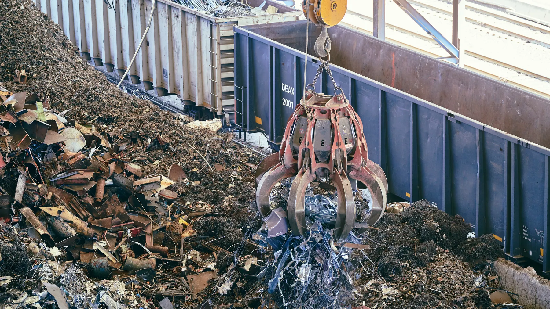 Greifkran hebt Metallschrott in einer großen industriellen Recyclinganlage als Titelbild für die Analyse europäischer Metallrecycler.