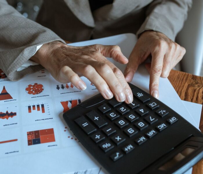 Finanzanalyst berechnet Kennzahlen anhand von Charts und Tabellen als Symbol für PEG Ratio, KGV und Gewinnwachstum.
